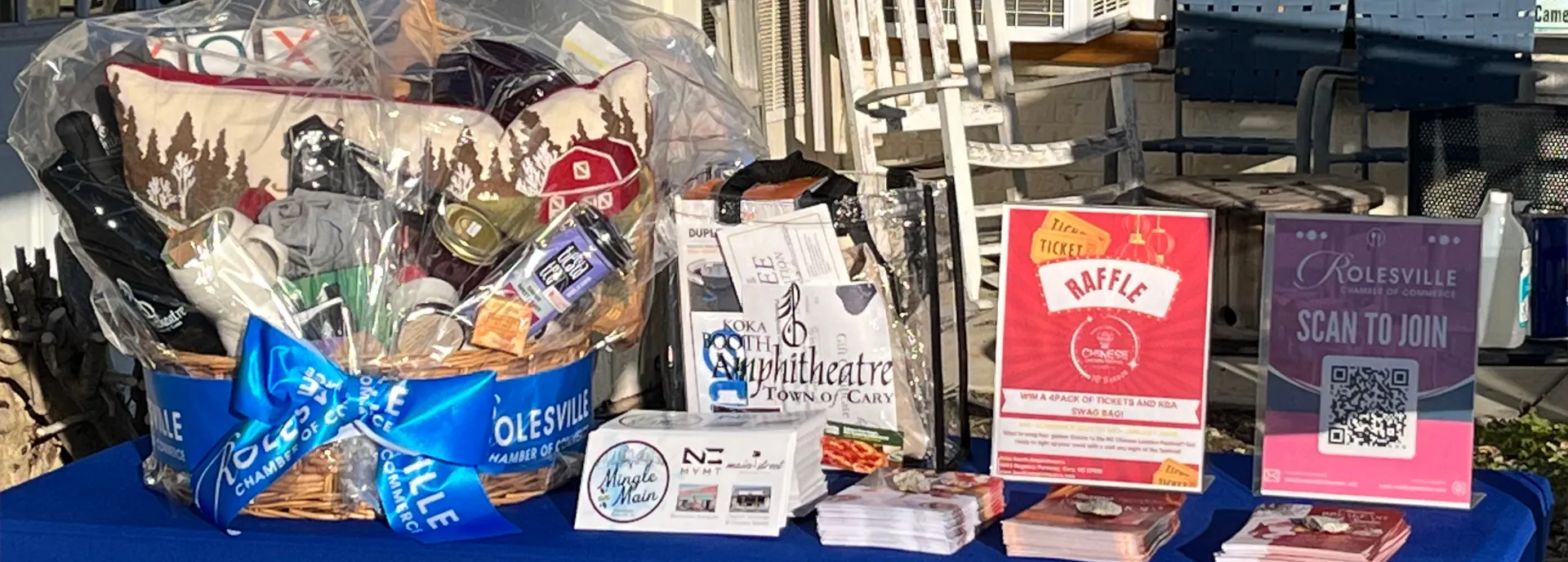 Rolesville Chamber's event booth table with signs for raffle and how to join